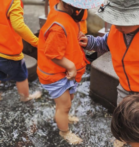 Toddlers at Amigoss Childcare co-op paddle in water The Co-op Federation Feature