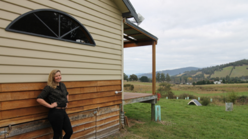 Eva Herrmann standing in front of the house she built in the Huon Valley The Co-op Federation